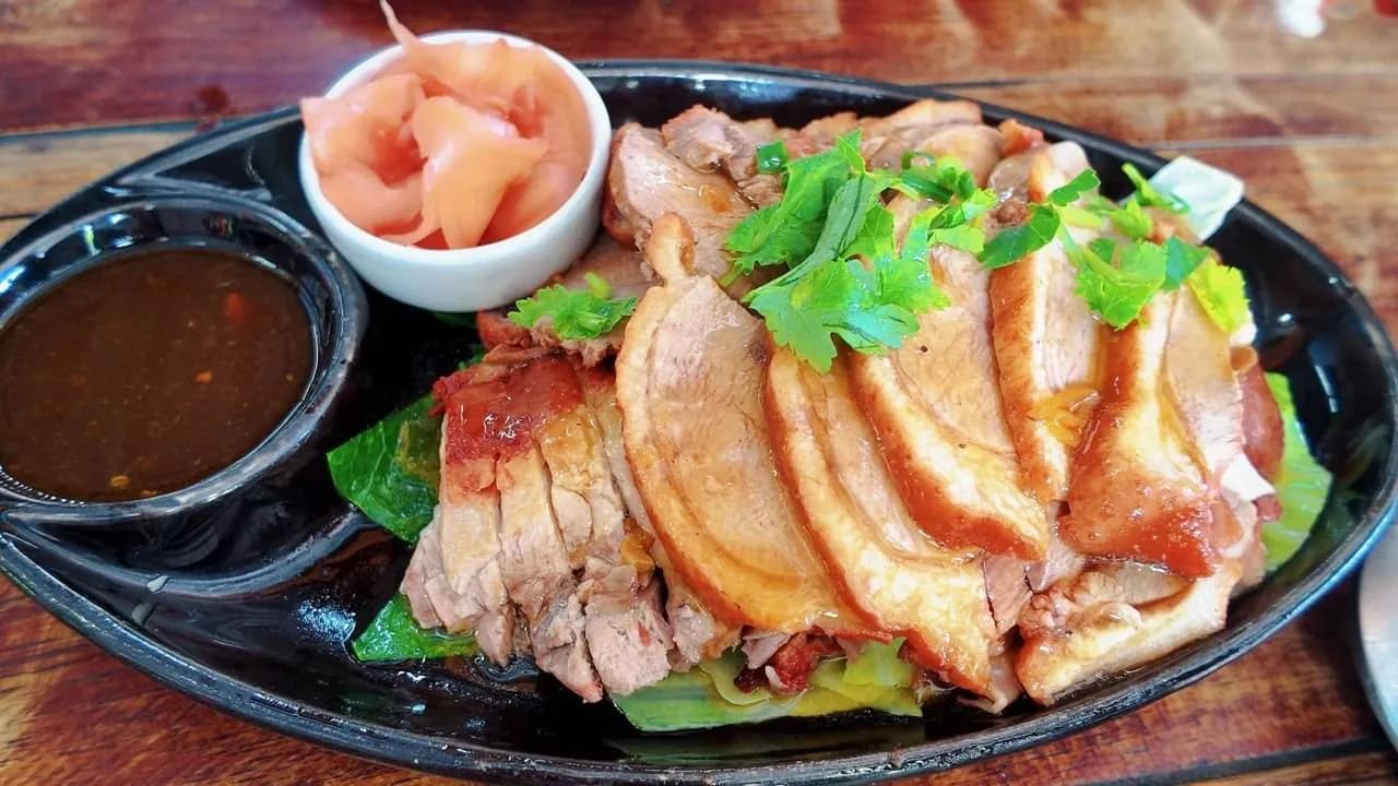 เป็ดหั่นชิ้นวางบนจาน มีน้ำจิ้มและขิงดอง